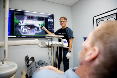 Dr. Soffer showing a restorative dentistry patient an x-ray of their mouth
