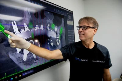Dr. Soffer with a dental implant x-ray of a patient